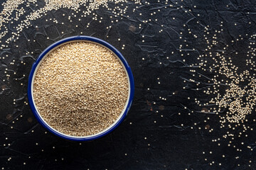 Quinoa in a bowl, healthy organic wood, uncooked, shot from the top with copy space