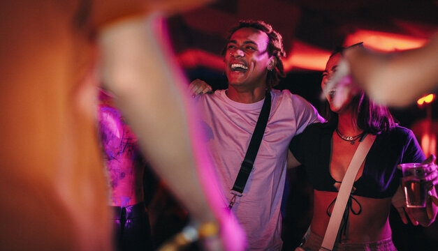Happy young people enjoying a fun night at a music festival