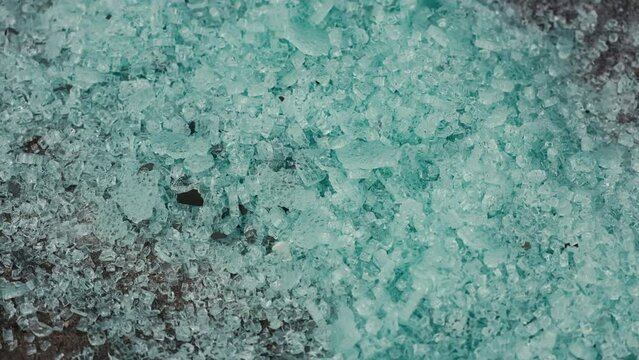 Close up of electric blue salt pile, resembling a pattern in nature, on a table