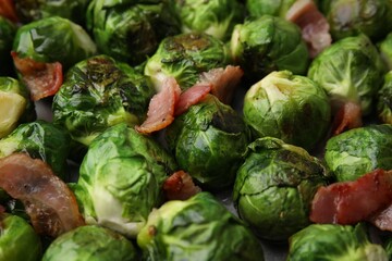 Delicious roasted Brussels sprouts and bacon as background, closeup