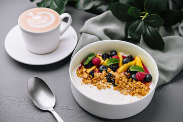 Healthy breakfast bowl with fresh fruit and latte art