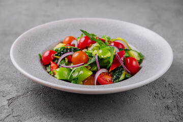 Fresh organic garden salad on gray plate