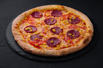 Appetizing pepperoni pizza on black background
