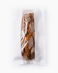 Fresh baguette in paper bag isolated on white