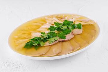 Traditional chicken aspic with parsley garnish