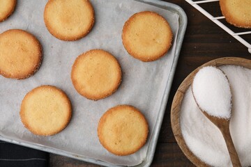 Tasty sweet sugar cookies on wooden table, flat lay