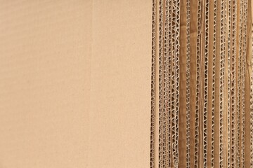 Sheets of brown corrugated cardboard as background, closeup