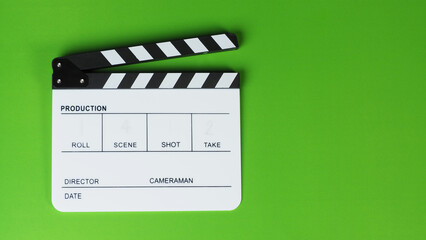 Clapper board or movie slate on green background..