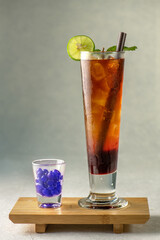 Ice tea menu colorful cool ice tea lemonade cocktails in glasses with straw on gray background. Mix...