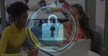 Image of cyber security text, lock icon, diverse female coworkers planning strategy over laptop