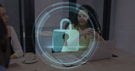 Image of cyber security text and lock icon over diverse woman sharing ideas with colleagues