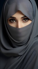 Naklejka premium Portrait of a veiled woman wearing burqa isolated on grey background