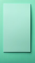 Mint Green background with dark mint green paper on the right side, minimalistic background, copy space concept, top view, flat lay