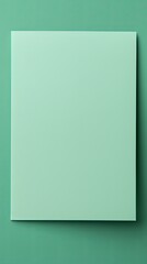 Mint Green background with dark mint green paper on the right side, minimalistic background, copy space concept, top view
