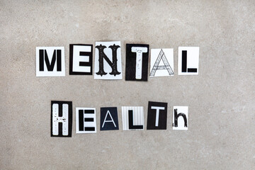 Mental health written in magazine cutout letters on mottled grey