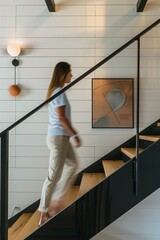 minimalist interior design, white walls with wooden beams on the ceiling, wood staircase, light brown stairs handrail, black metal balustrade, woman walking up the stairwell, architectural photography
