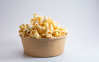 Popcorn in a disposable bowl isolated on white background. 