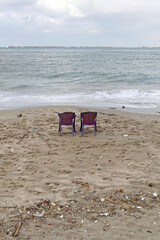 Two Purple Plastic Chairs at Polluted Beach Mediterranean Sea
