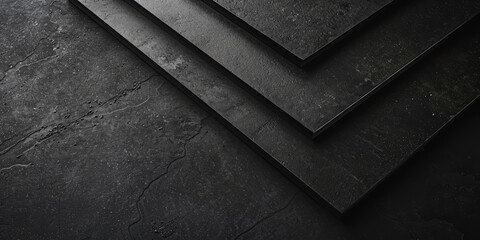 Close-up of a dark black textured surface with angular lines and geometric shapes that create a sense of modernity and elegance.