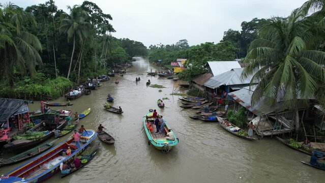 Wooden and metal boats are seen in the river which is the floating market of Bangladesh