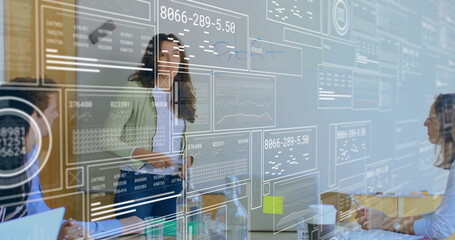Image of screens with data processing over diverse business people in office