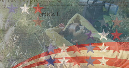 Image of stripes and stars moving over woman lying on meadow