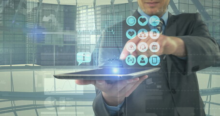 Image of digital icons and financial data processing over businessman holding tablet - Powered by Adobe