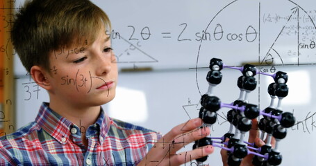 Image of mathematical formulae over smiling schoolboy - obrazy, fototapety, plakaty