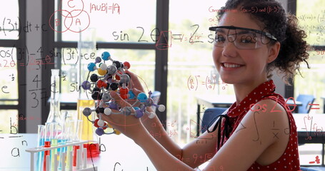 Image of mathematical formulae over smiling schoolgirl - obrazy, fototapety, plakaty