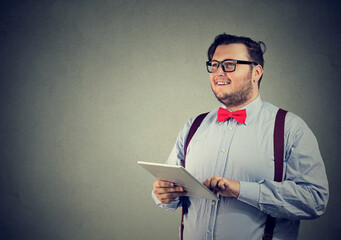 Happy smiling businessman with a tablet computer  - 785248266