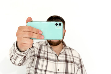 European fat emotional young man with phone on white background