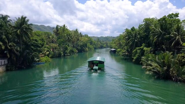 Following one of the boats of the Loboc river cruise, one of the popular attractions in Bohol, Philippines.