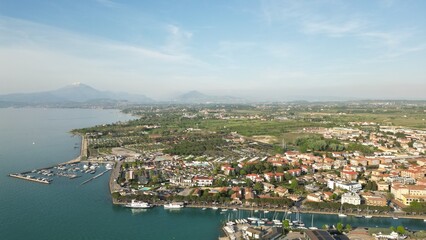 Aerial view of the city of Peschiera del Garda, Italy. Beautiful view from a drone of the city, lake and mountains