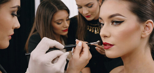 Makeup Artist Creating a Look for a Fashion Show. array of brushes and palettes at hand, meticulously creates a stunning look for a model at a fashion show. The concentration and creativity 