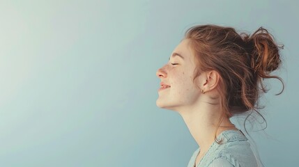 Joyful young woman with a beaming smile and closed eyes, expressing genuine happiness and carefree attitude - obrazy, fototapety, plakaty