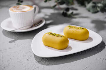 Gourmet pistachio desserts with latte on concrete table
