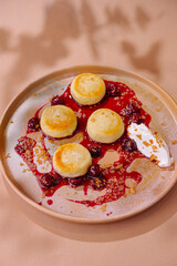 Gourmet cheese pancakes with berry sauce
