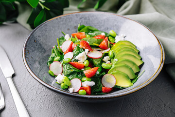Fresh spinach avocado salad on stylish plate
