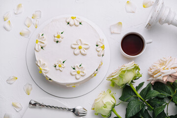 Elegant white floral cake with tea setting
