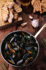 Appetizing mussels in herb broth with bread