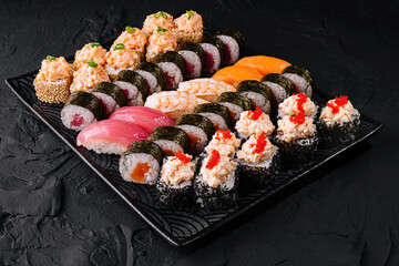 Assorted sushi platter on a black slate