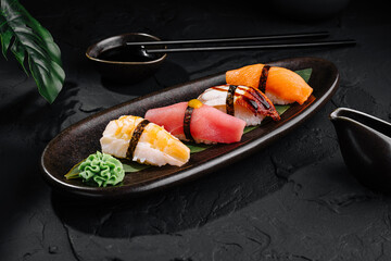 Assorted nigiri sushi on elegant dark plate