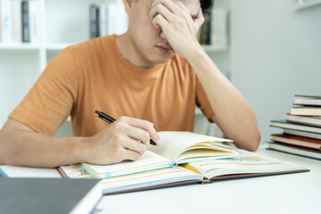 Asian student man have anxiety because of exams, male prepare for test and learning lessons in the...