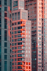 Naklejka premium A closeup of skyscrapers in a city during nighttime using a telephoto lens