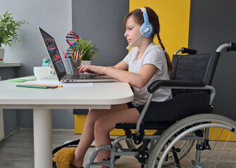 Young Girl Sitting in Wheelchair Using Laptop