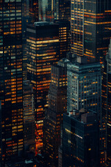 A closeup of skyscrapers in a city during nighttime using a telephoto lens
