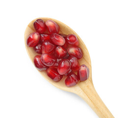 Ripe juicy pomegranate grains in wooden spoon isolated on white, top view