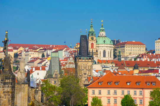 Famous Charles Bridge on Vltava River and beautiful buildings of the old town of Prague, Czech Republic, in sunny day