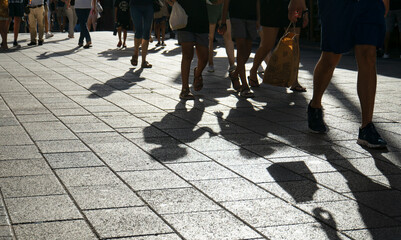 Urban shadows of people walking on a sunny street in Playa del Carmen, Mexico