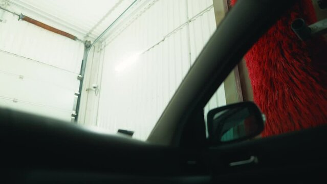 Foam Delight: Indulge in the sensory delight of an automatic car wash as your vehicle is bathed in luxurious foam, captured from inside for an immersive viewing experience.